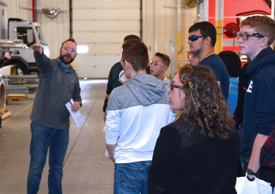 Spartan Motors' Production Supervisor Collin Seigle guides students from Charlotte High School's STEM program around Spartan Motors headquarters in Charlotte, Michigan.
